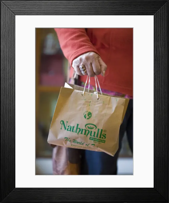 Framed Print : India, West Bengal, Darjeeling, Nathmulls tea shop, Woman holding bag of tea Framed Print : India, West Bengal, Darjeeling, Nathmulls tea shop, Woman holding bag of tea