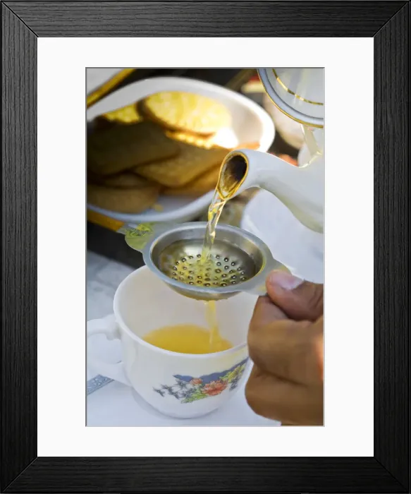 Framed Print : India, West Bengal, Darjeeling, Arya Tea Estate, Manager pouring cup of tea