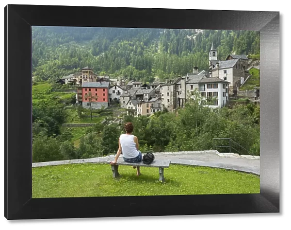 Europe, Switzerland, Ticino, Maggia Valley, A woman admiring Fusio village