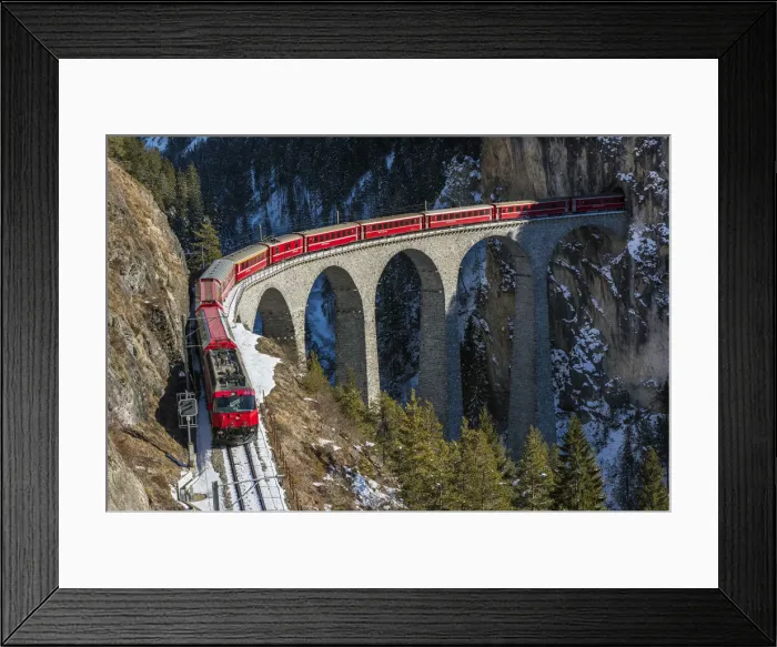 Framed Print : The famous red train of Albula mountain railway while passing on the Landwasser viaduct Framed Print : The famous red train of Albula mountain railway while passing on the Landwasser viaduct