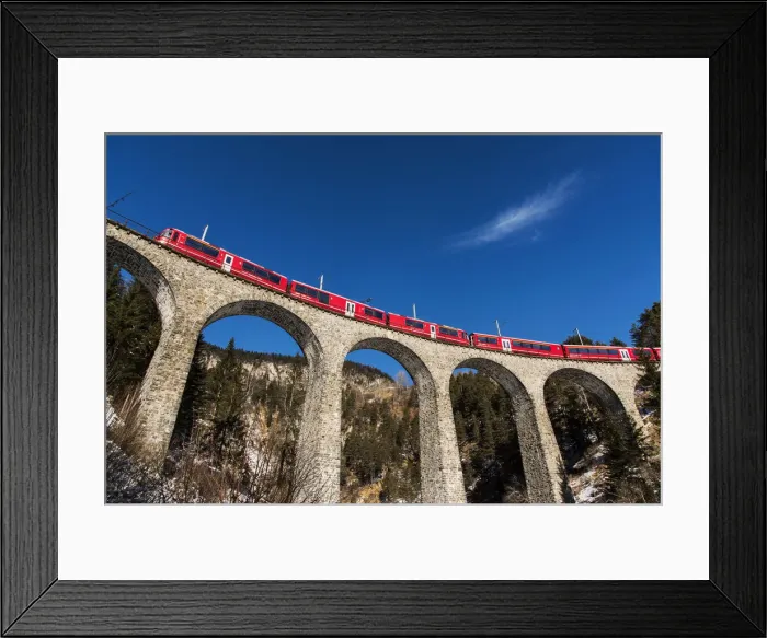 Framed Print : The famous red train of Albula mountain railway while passing on the Landwasser viaduct Framed Print : The famous red train of Albula mountain railway while passing on the Landwasser viaduct