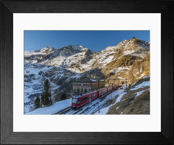 Framed Print : The famous Bernina Express red train at Alp Grum station in a scenic winter day Framed Print : The famous Bernina Express red train at Alp Grum station in a scenic winter day