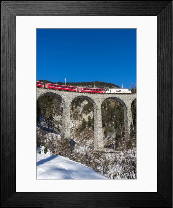 Framed Print : The famous red train of Albula mountain railway while passing on the Landwasser viaduct