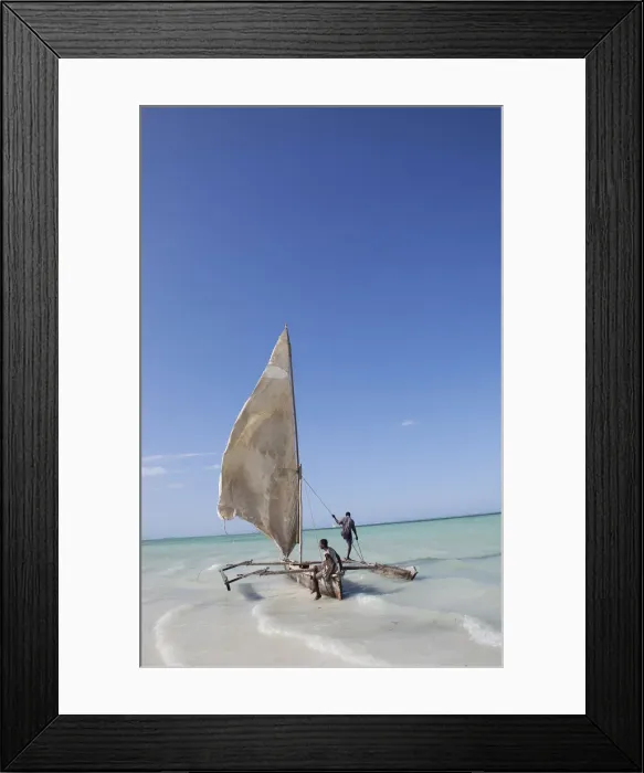 Framed Print : Two men sailing a boat in the surf off Zanzibar in East Africa Framed Print : Two men sailing a boat in the surf off Zanzibar in East Africa