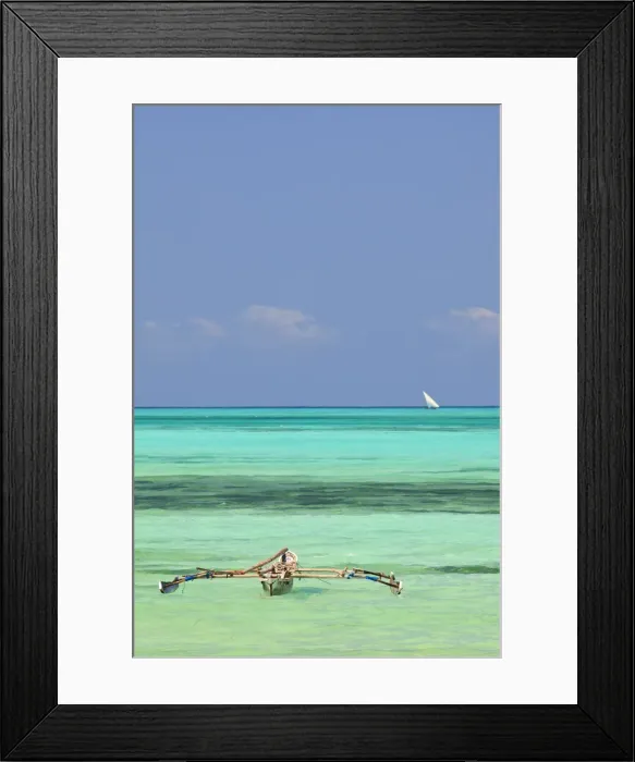 Framed Print : Tanzania, Zanzibar, Unguja, Jambiani. A traditional dhow moored near the shore