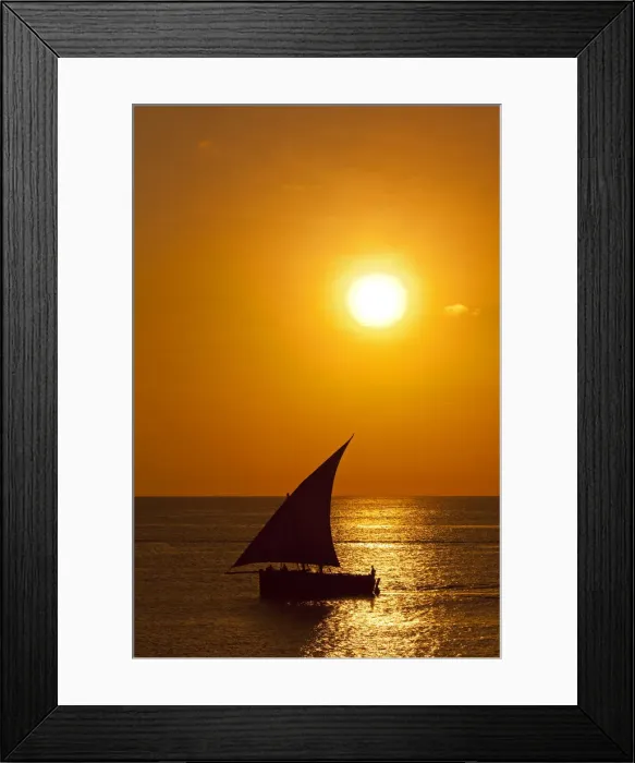 Framed Print : Tanzania, Zanzibar, Unguja, Stone Town. A Dhow sails out of the harbour at sunset Framed Print : Tanzania, Zanzibar, Unguja, Stone Town. A Dhow sails out of the harbour at sunset