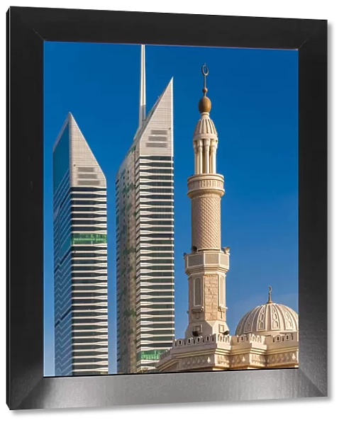 Mosque minaret with skyscrapers in the background, Dubai, United Arab Emirates