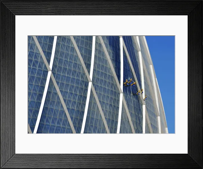 Framed Print : Window cleaners hanging on The Coin building Aldar headquarters, one of the largest