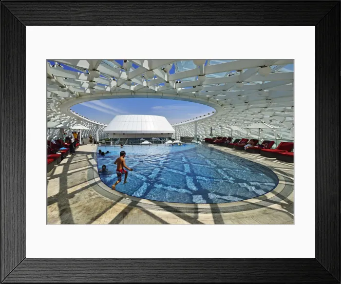 Framed Print : A boy jumps into the swimming pool of the Yas Marina Circuit Formula 1 race track Framed Print : A boy jumps into the swimming pool of the Yas Marina Circuit Formula 1 race track
