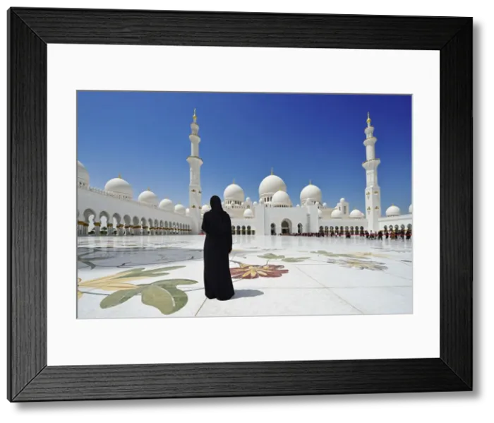 Framed Print : Woman in a black burkha stands in front of Sheikh Zayed Mosque, Abu Dhabi, United Framed Print : Woman in a black burkha stands in front of Sheikh Zayed Mosque, Abu Dhabi, United