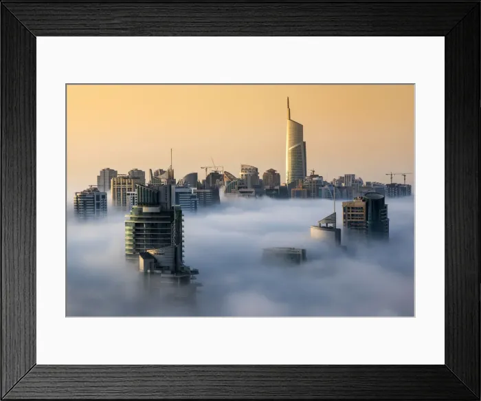 Framed Print : Foggy sunrise with Dubai Marinas skyscrapers towering over the low clouds Framed Print : Foggy sunrise with Dubai Marinas skyscrapers towering over the low clouds