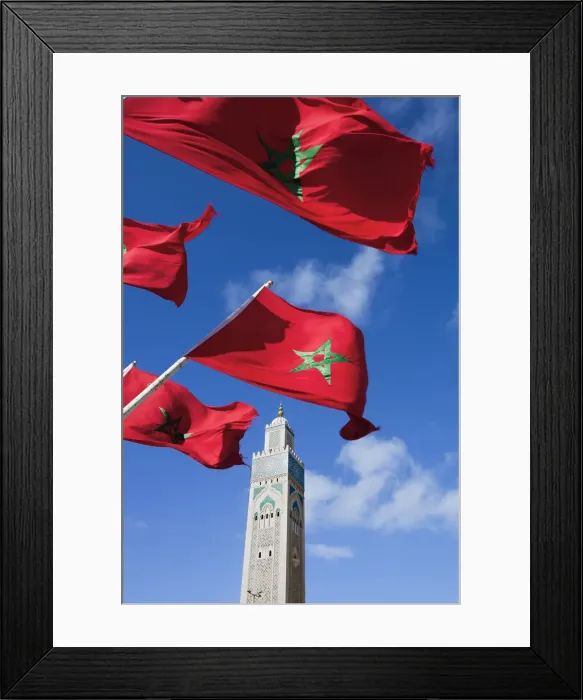 Framed Print : Flags of Morocco waving in the wind and Hassan II Mosque, the third largest mosque Framed Print : Flags of Morocco waving in the wind and Hassan II Mosque, the third largest mosque