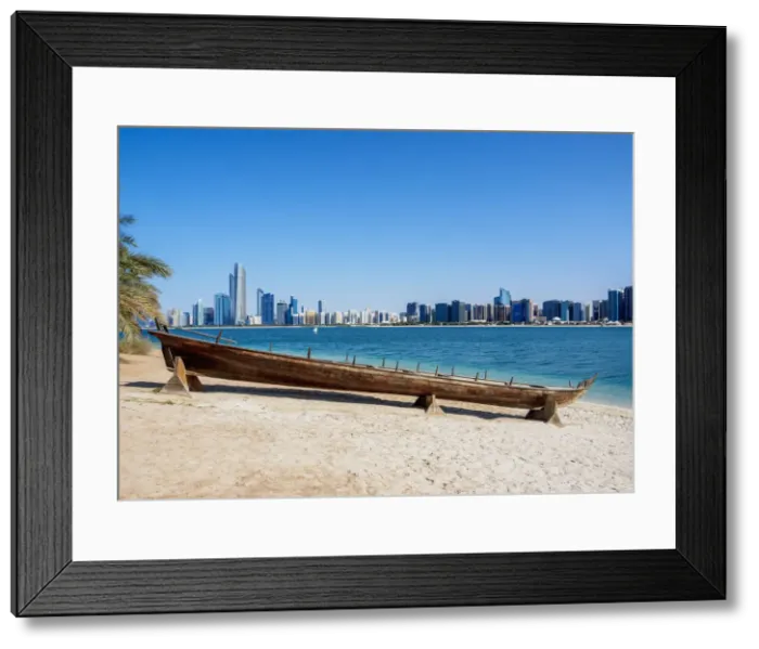 Framed Print : Traditional boat in the Heritage Village with city skyline in the background, Abu Dhabi Framed Print : Traditional boat in the Heritage Village with city skyline in the background, Abu Dhabi