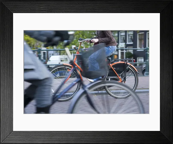 Framed Print : Holland, Amsterdam, riding a bicycle over a canal bridge