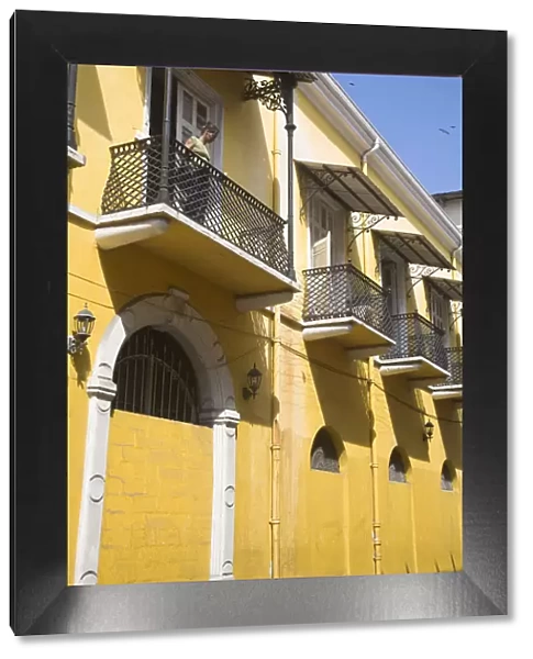 Panama, Panama City, Woman standing on balcony in Casco Viejo (San Felipe)