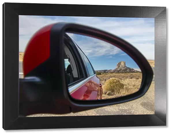 Desert landscape with lonely butte hill reflected into a car side mirror, Navajo Nation