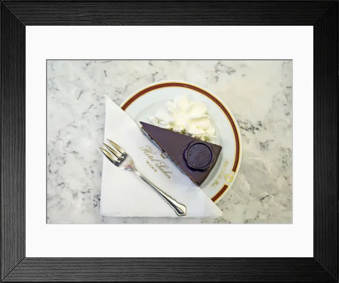 Framed Print : A slice of Original Sacher - Torte cake with whipped cream at Hotel Sacher, Vienna