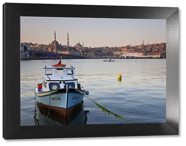 Boat on The Bosphorus, mosque on skyline, Istanbul, Turkey