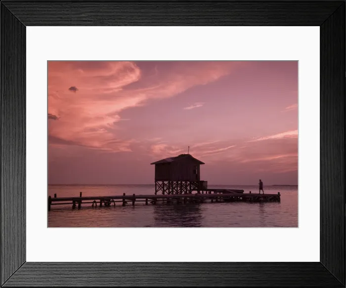 Framed Print : Belize, Tobaco Caye, Man on pier at sunset Framed Print : Belize, Tobaco Caye, Man on pier at sunset