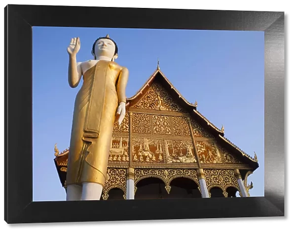 Laos, Vientiane, Pha That Luang, Buddha Statue at Sunrise