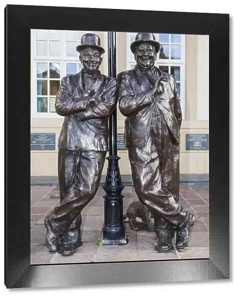 England, Cumbria, Lake District, Ulverston, Statue of Laurel and Hardy in front of