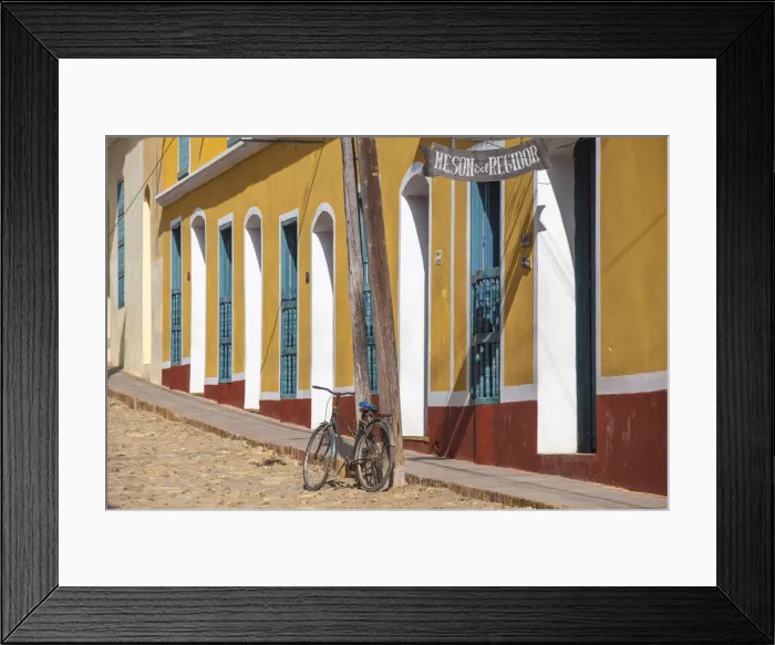 Framed Print : Cuba, Trinidad, Bike leaning against lamp post by colourful houses