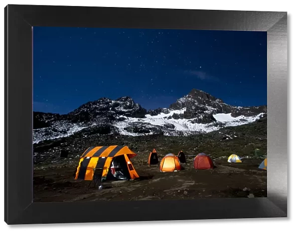 Camping under the full moon, night shot of Mount Kilimanajro with tents