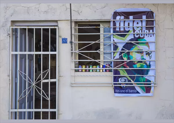 Cuba, Havana, Buildings on The Malecon, Poster of Fidel on shop wall after the death