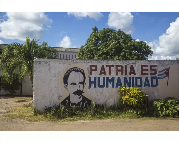 Cuba, Villa Clara province, Remedios, Bus station, Revolutionary slogan painted on wall