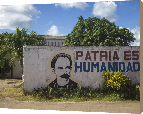 Cuba, Villa Clara province, Remedios, Bus station, Revolutionary slogan painted on wall