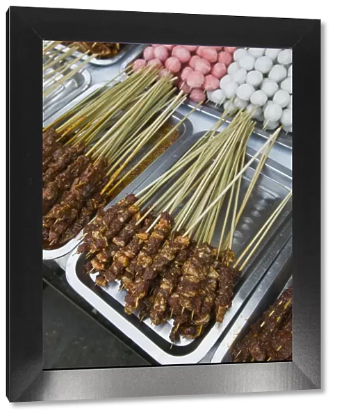 China, Yunnan Province, Erhai Hu Lake Area, Xizhou, town market, meat skewers at food