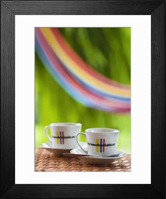 Framed Print : Colombia, Caldas, Manizales, Hacienda Venecia, Coffee cups on table with hammock in
