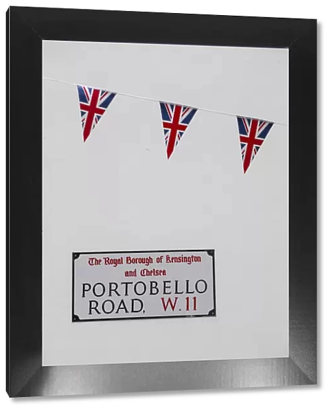 UK, England, London, Kensington, Union Jack bunting above Portobello Rd sign to celebrate