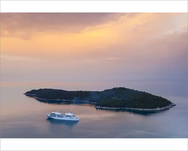 Cruiseboat and island illuminated at sunrise, Dubrovnik, Dalmatia, Croatia