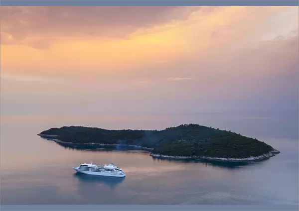 Cruiseboat and island illuminated at sunrise, Dubrovnik, Dalmatia, Croatia