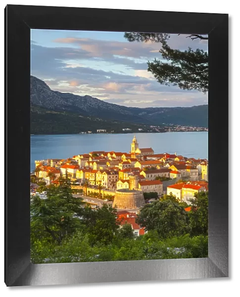 Elevated view over picturesque Korcula Town illuminated at sunset, Korcula, Dalmatia