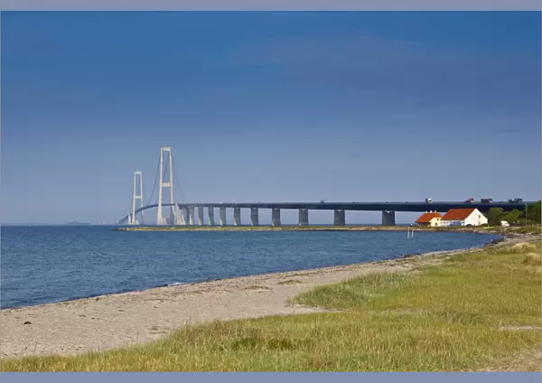 A white sand beach leads towards the East Bridge as seen from Korsor, Denmark