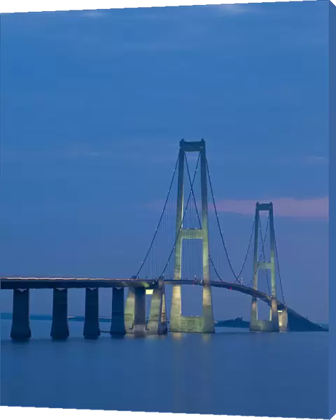 Dusk over the illuminated East Bridge as seen from Korsor, Denmark