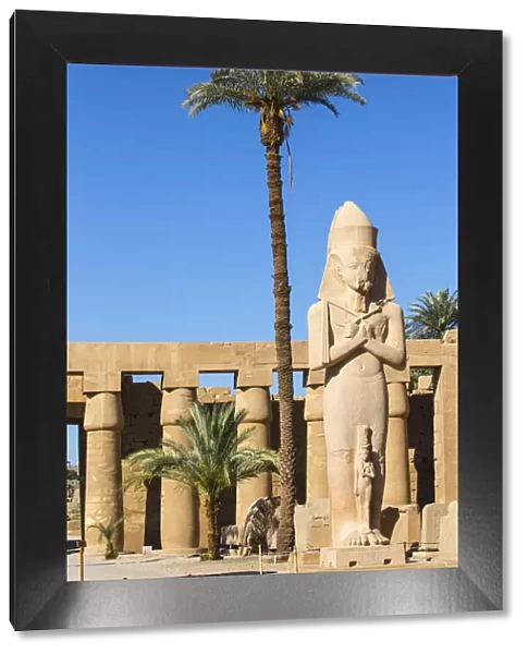 Egypt, Luxor, Karnak Temple, Colossal statue of King Ramesses II with his daughter