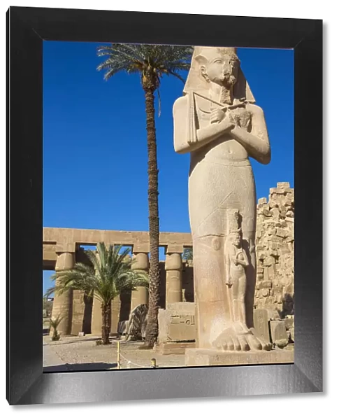 Egypt, Luxor, Karnak Temple, Colossal statue of King Ramesses II with his daughter