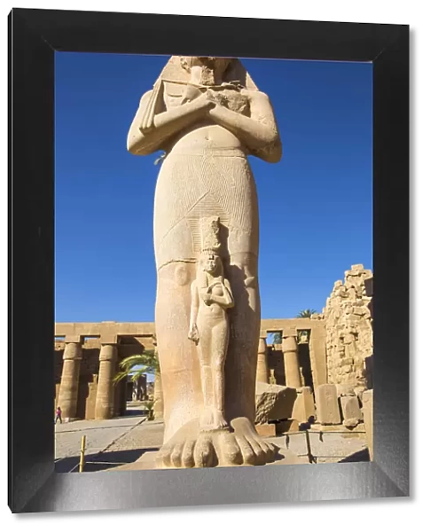 Egypt, Luxor, Karnak Temple, Colossal statue of King Ramesses II with his