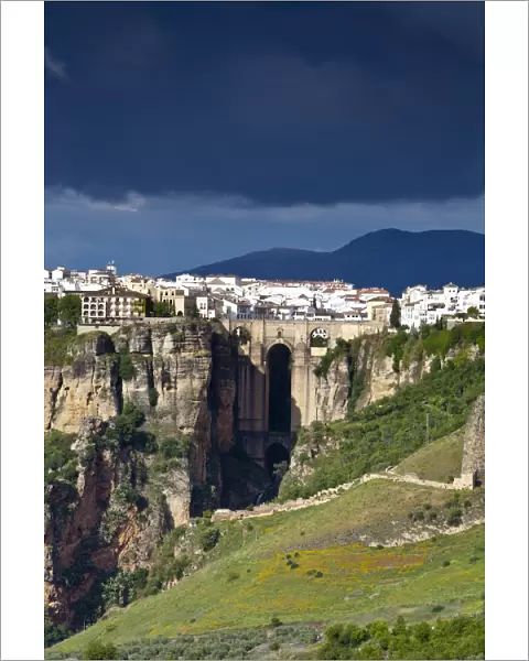 Moody storm clouds & contrasty light over Puento Nuevo & the White Village of Ronda