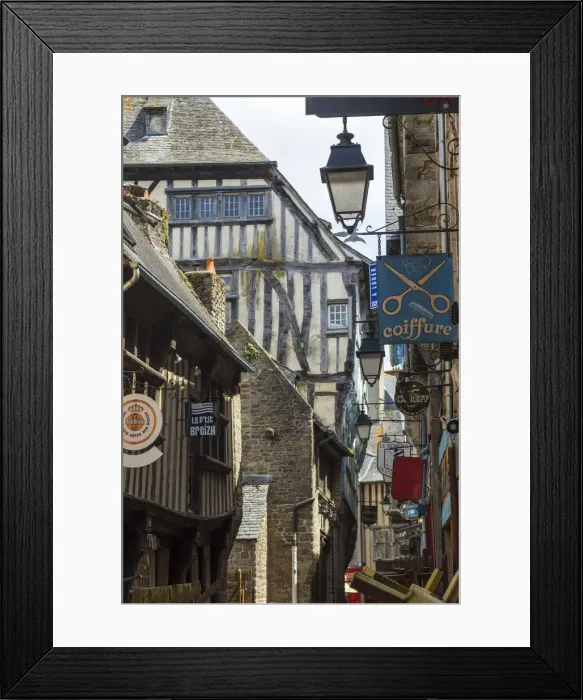 Framed Print : Medieval half-timbered houses and shop signs, Dinan, Brittany, France Framed Print : Medieval half-timbered houses and shop signs, Dinan, Brittany, France
