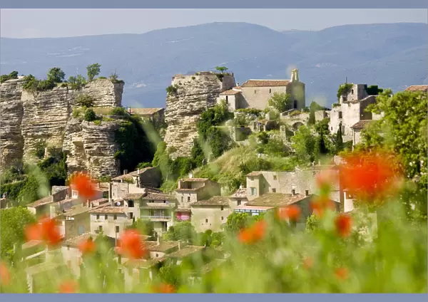 Saignon, Luberon, Provence, France. Poppies & view of village