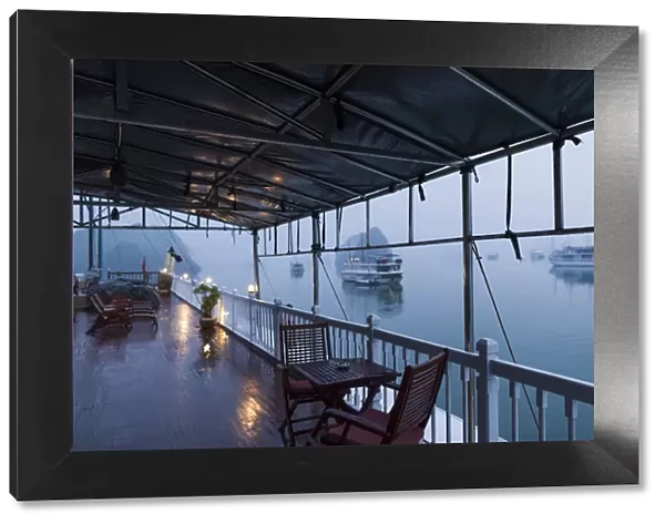 Vietnam, Halong Bay, tourist boat, deck view, dawn