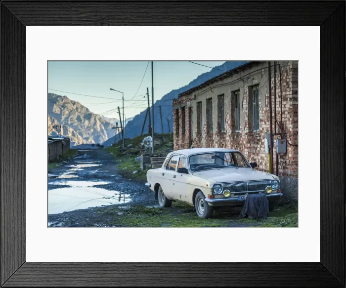 Framed Print : Georgia, Georgian Military Highway, Kazbegi-Stepantsminda, Soviet-era Volga car, GAZ-24