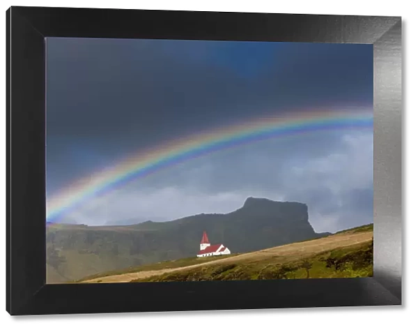 Rainbow over church, Vik, Iceland