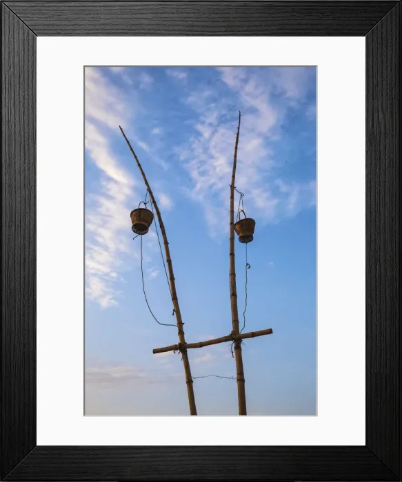 Framed Print : India, Uttar Pradesh, Varanasi, Sindhia Ghat, Wicker baskets on bamboo poles containing Framed Print : India, Uttar Pradesh, Varanasi, Sindhia Ghat, Wicker baskets on bamboo poles containing