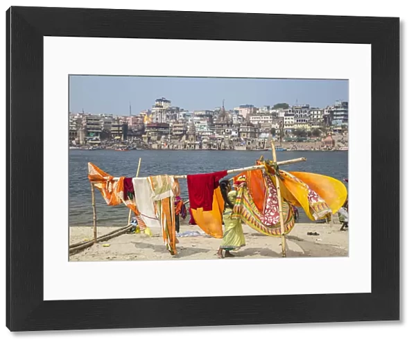 India, Uttar Pradesh, Varanasi, Hanging up washing on banks of Ganges river