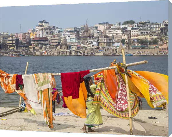 India, Uttar Pradesh, Varanasi, Hanging up washing on banks of Ganges river